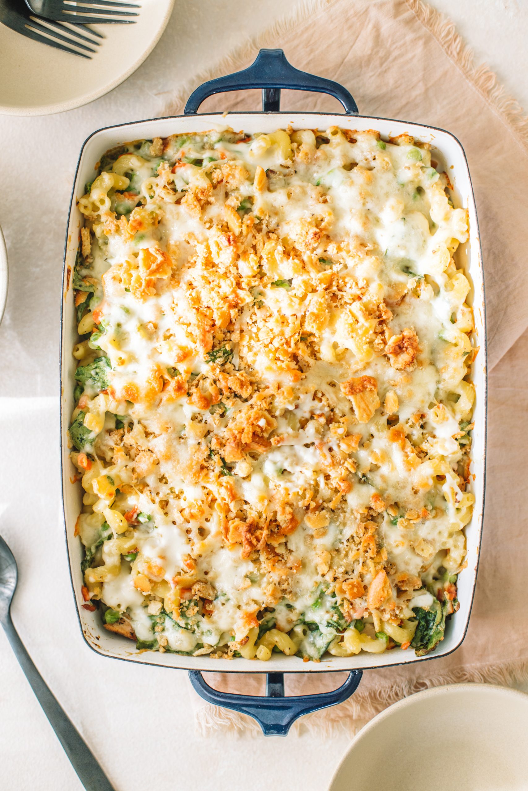 A casserole dish filled with tuna noodle casserole from scratch that has been baked.