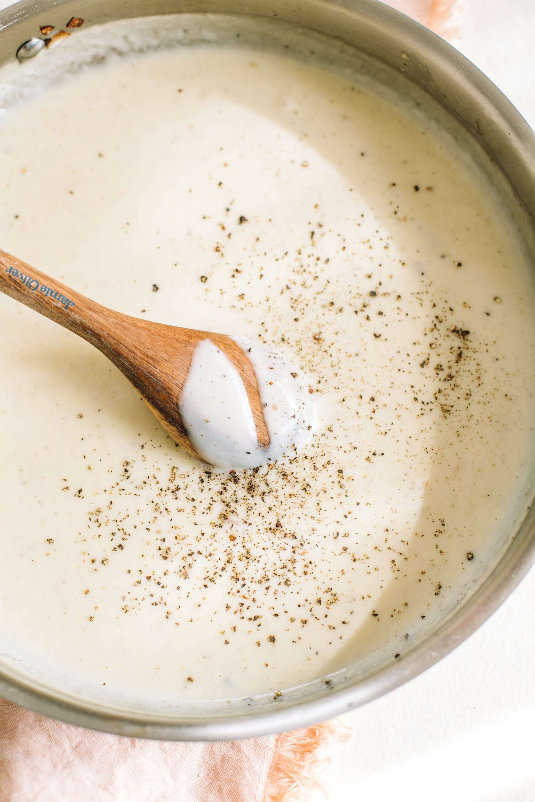 A savory cream sauce in a medium sauté pan. 