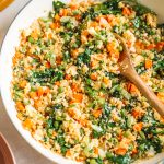 A yellow skillet filled with cauliflower fried rice.