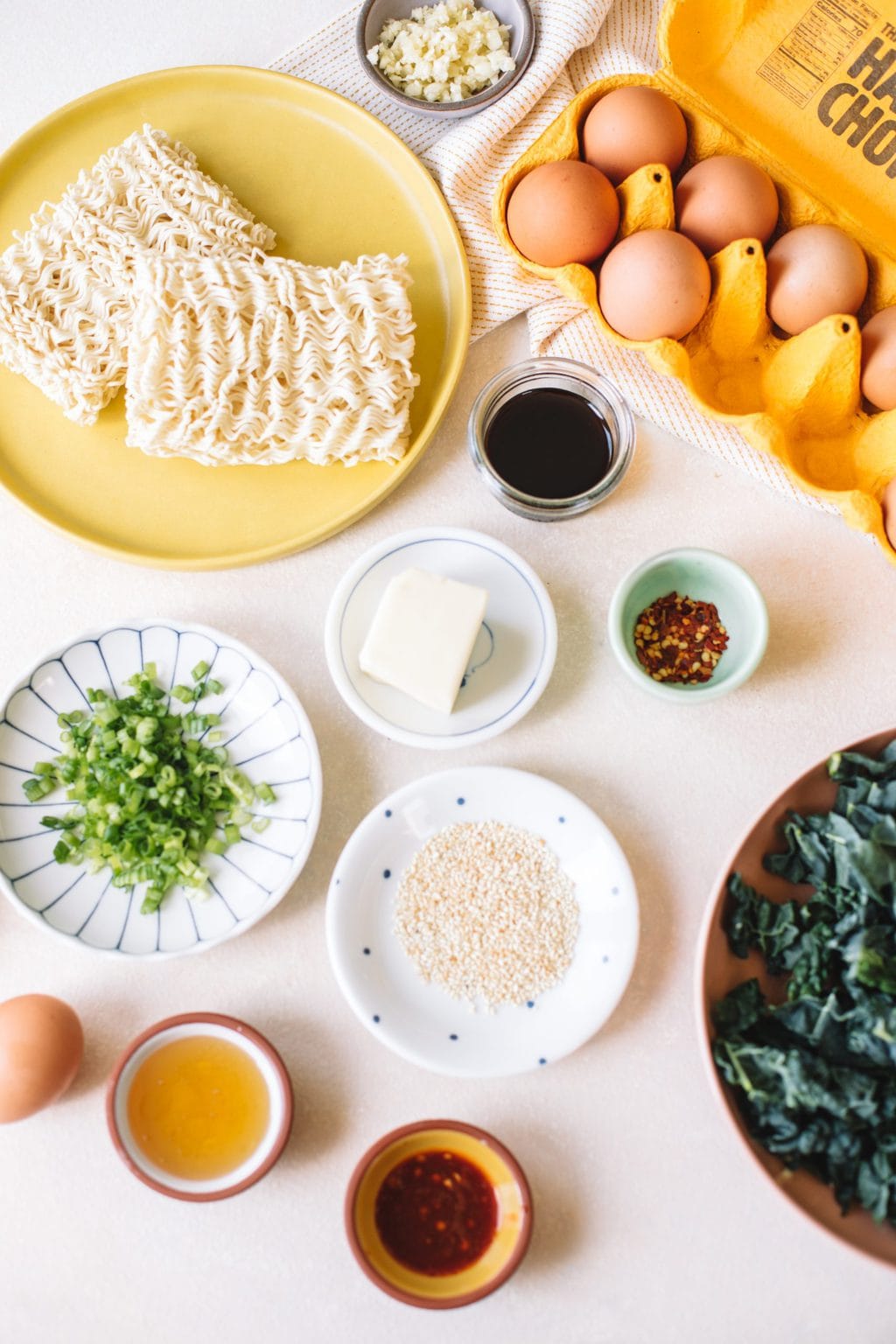 Ingredients in small bowls and on plates for Garlic Butter Ramen Noodle Stir Fry. 