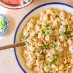 Hawaiian macaroni salad served in a white serving dish with a blue rim.