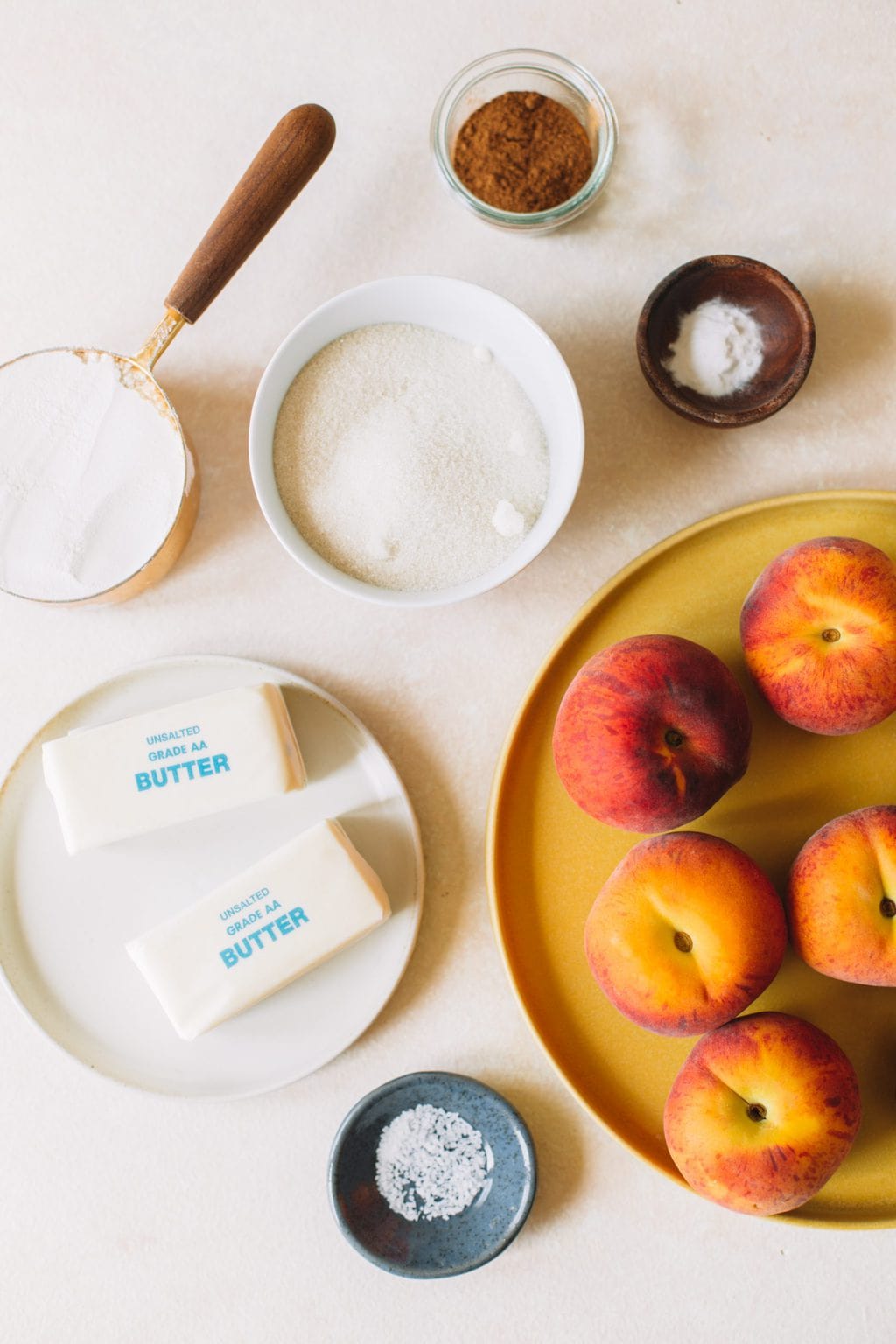 Ingredients in small bowls for peach cobbler.