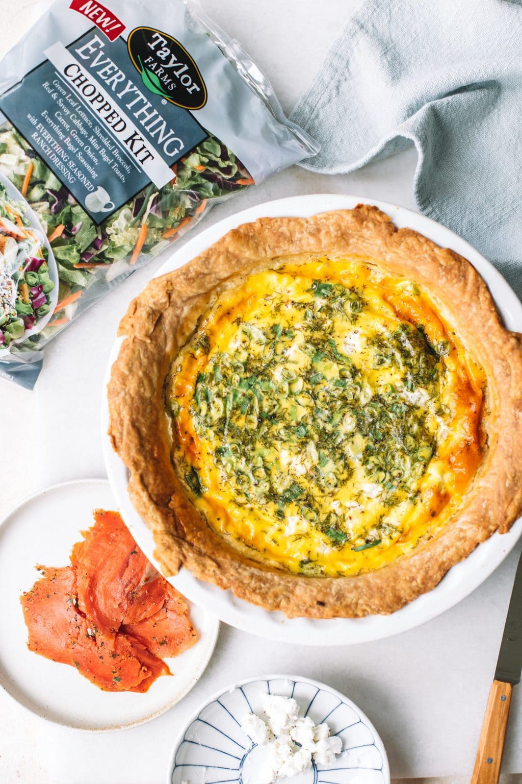 Baked quiche serve with an everything bagel salad kit.