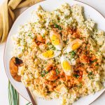 easy egg potato salad recipe in white bowl with gold spoon