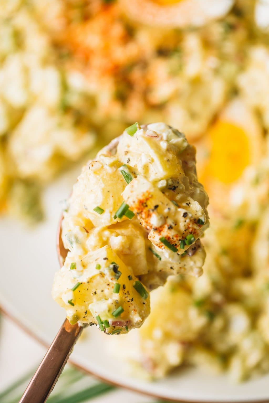 large spoonful of homemade deviled egg potato salad