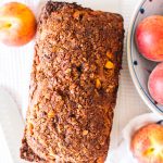 Loaf of peach bread with a cinnamon crunch topping.