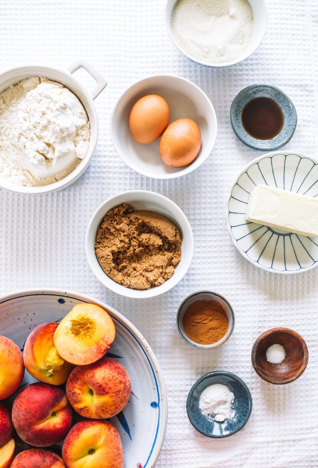 Ingredients in small bowls for peach bread.