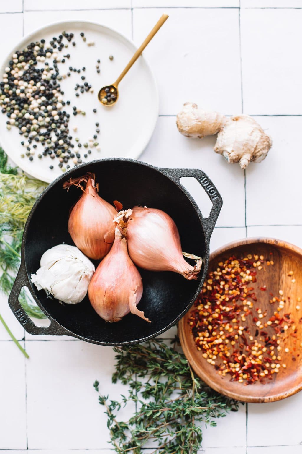 onions, garlic in stockpot with red papper flakes in brown bowl