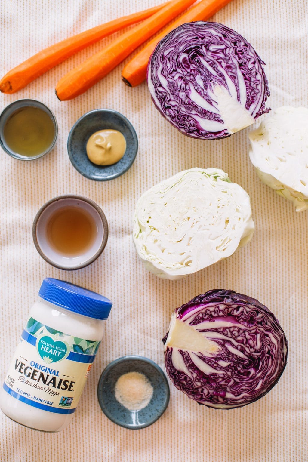 Carrots, purple cabbage, green cabbage, apple cider vinegar, maple syrup, dijon mustard, onion powder, and vegan mayonnaise.
