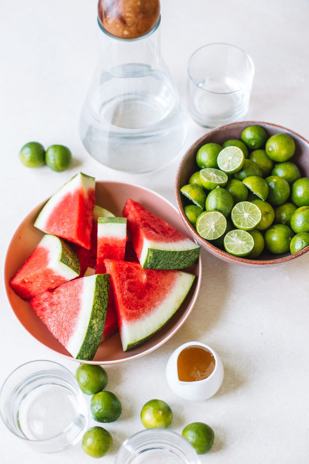 Bowls of watermelon and limes with agave and vodka.