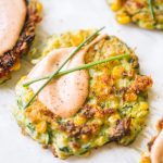 easy vegetable fritters topped with creamy dipping sauce and chives