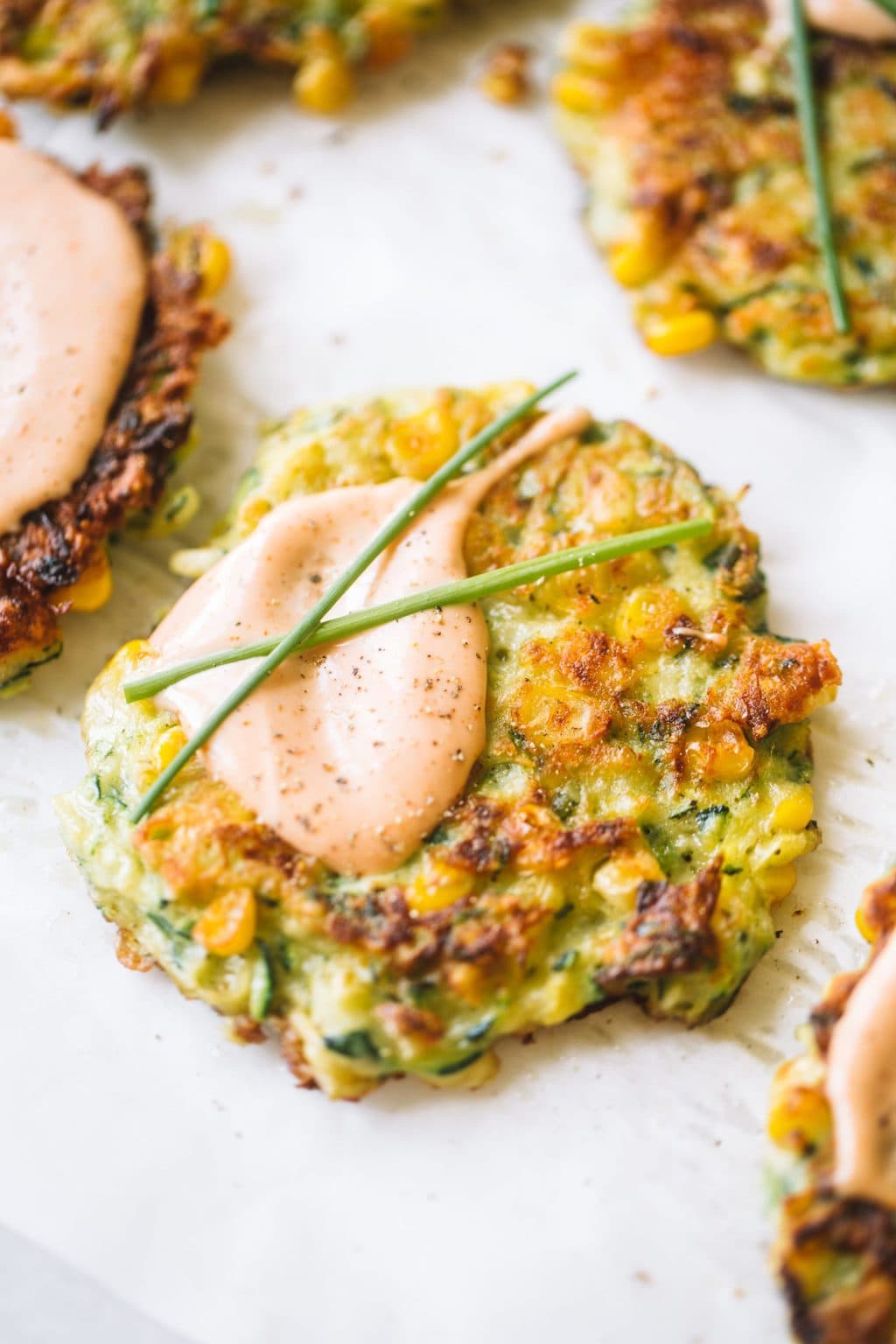 easy vegetable fritters topped with creamy dipping sauce and chives