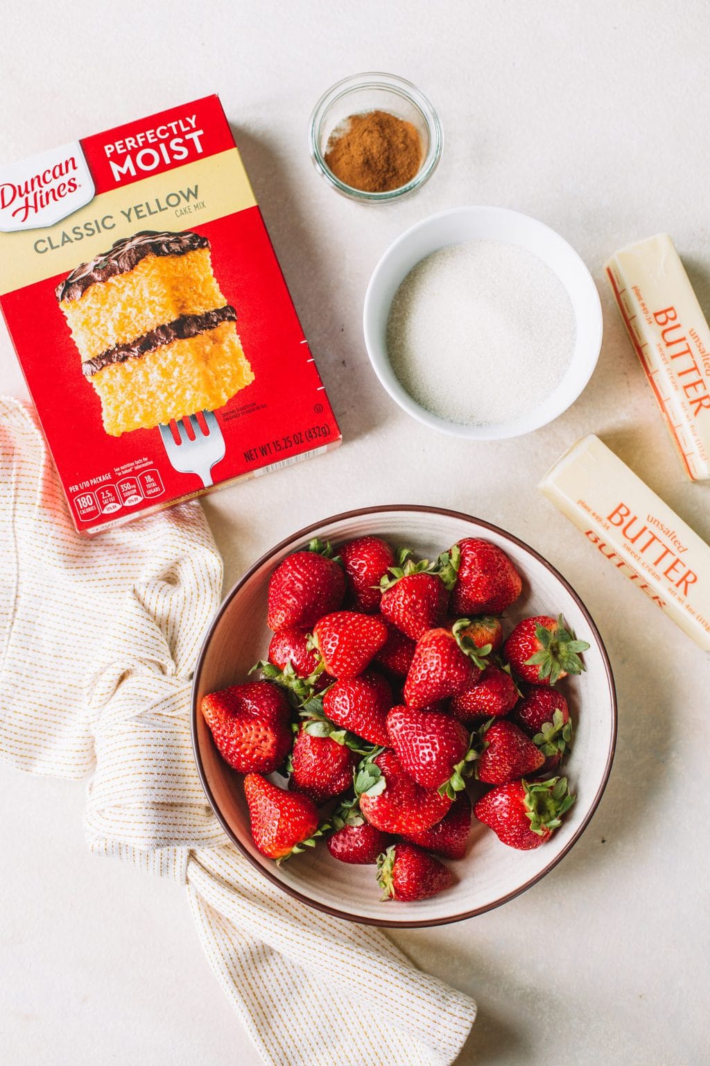 Boxed yellow cake mix, strawberries, butter, sugar and cinnamon.