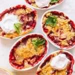 Strawberry dump cakes baked in small white ramekins.