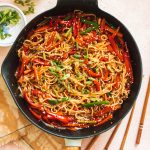 easy chili garlic noodles and sauce with vegetables in cast iron pan