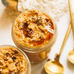 two small mason jars of pumpkin overnight oats with oats and gold spoon