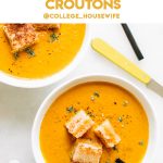 creamy pumpkin soup recipe in two white bowls with grilled cheese croutons