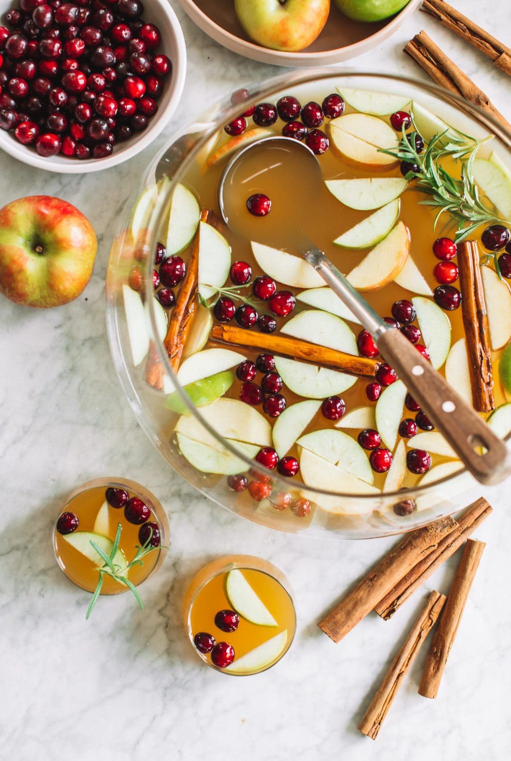 A punch bowl of apple cider sangria with a ladle. 