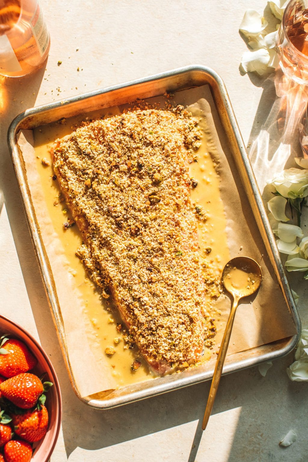 Pistachio crusted salmon pre baked on a baking sheet. 