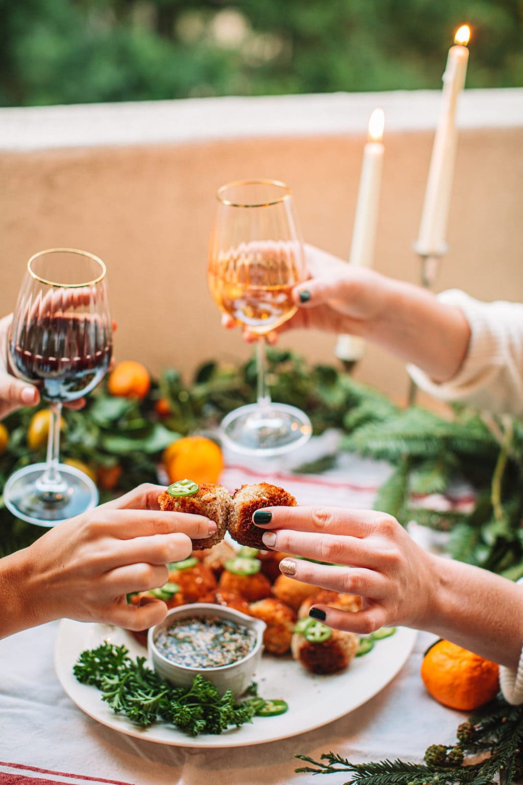 Glasses of wine and spicy tuna croquettes having a cheers.