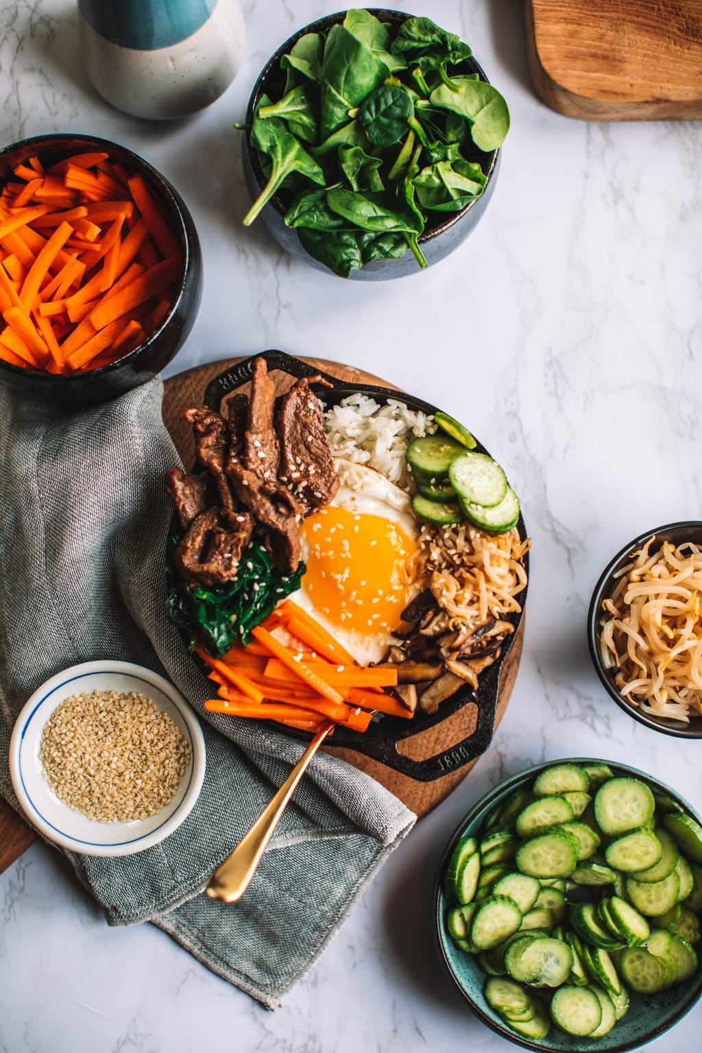 top shot of rice bowl and ingredients in smaller bowls alongside