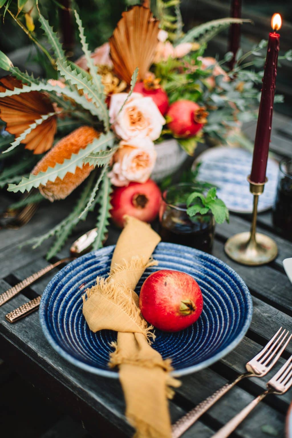 blue plate with yellow napkin on wooden table next to pastel flours