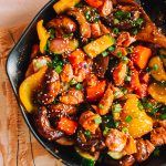 salmon stir fry with vegetables in cast iron skillet