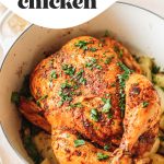 Top shot of whole chicken cooking in large pot on top of vegetables with text overlay.