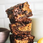 Fudgy Banana Bread Brownies in a stack with fudgy centers.