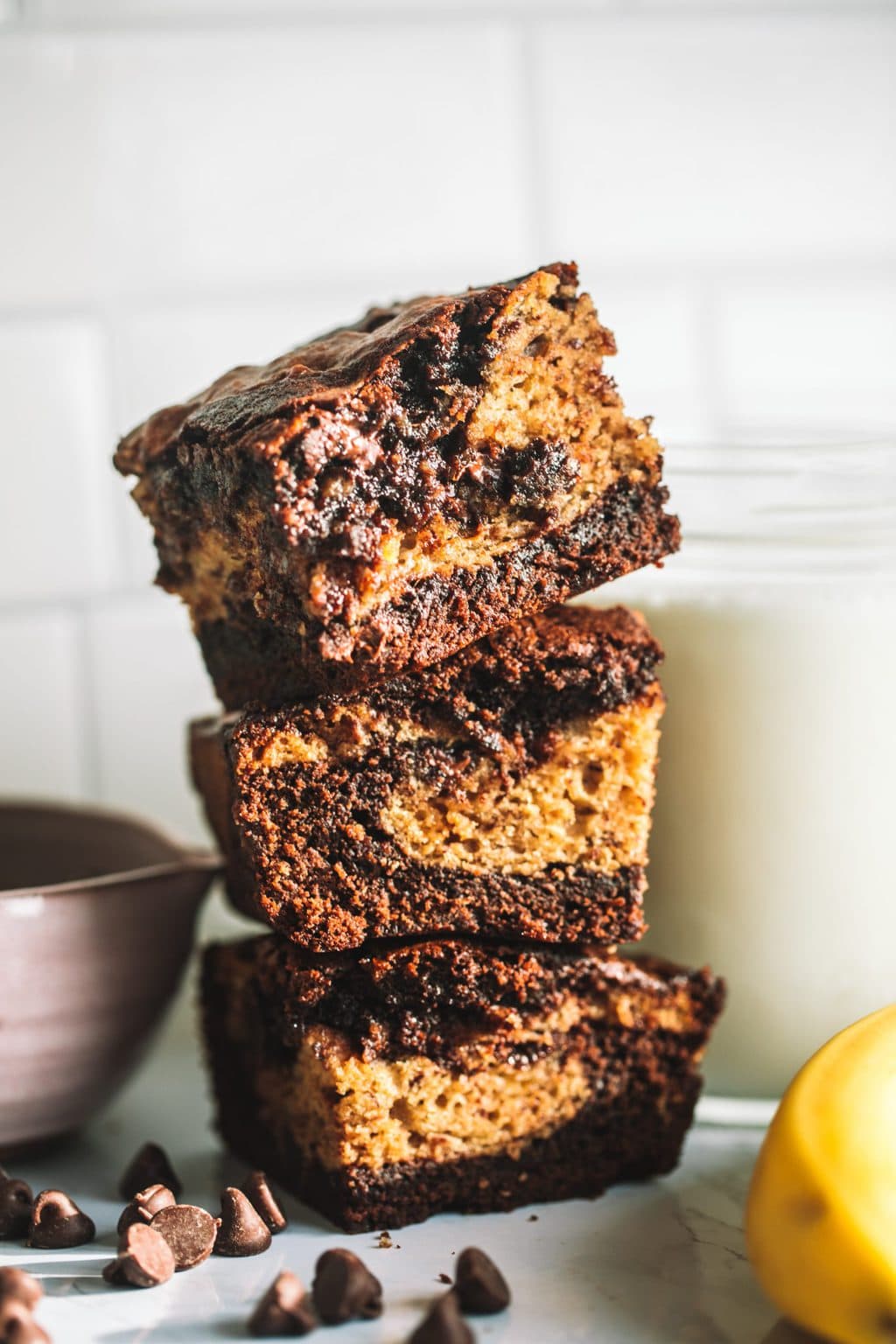 Fudgy Banana Bread Brownies in a stack with fudgy centers.