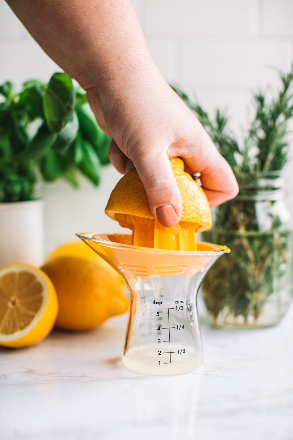 Close up shot of woman getting lime juice out of fresh lime wedge.