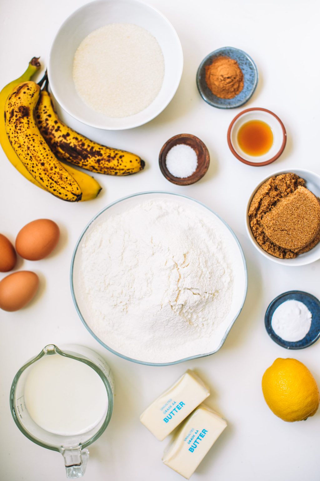 Ingredients for caramel and banana cake spread out on white countertop.