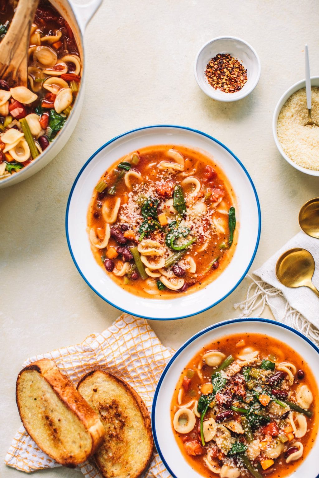 Top shot of two bowls of Minestrone Soup Olive Garden Style next to slices of toast.