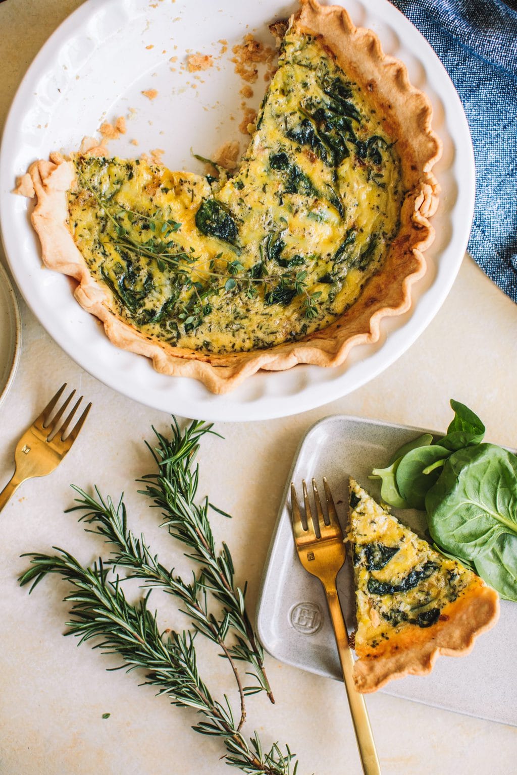 quiche florentine in pie crust with slice of spinach quiche on side