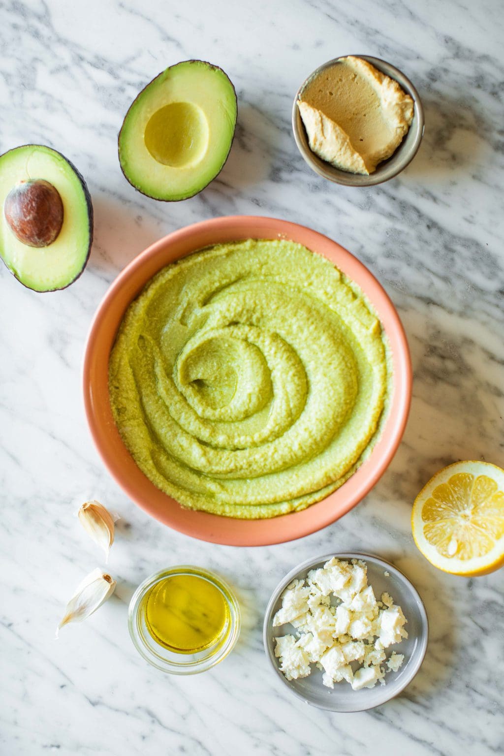 Avocado halves, hummus, garlic cloves, olive oil, feta cheese and lemon juice.