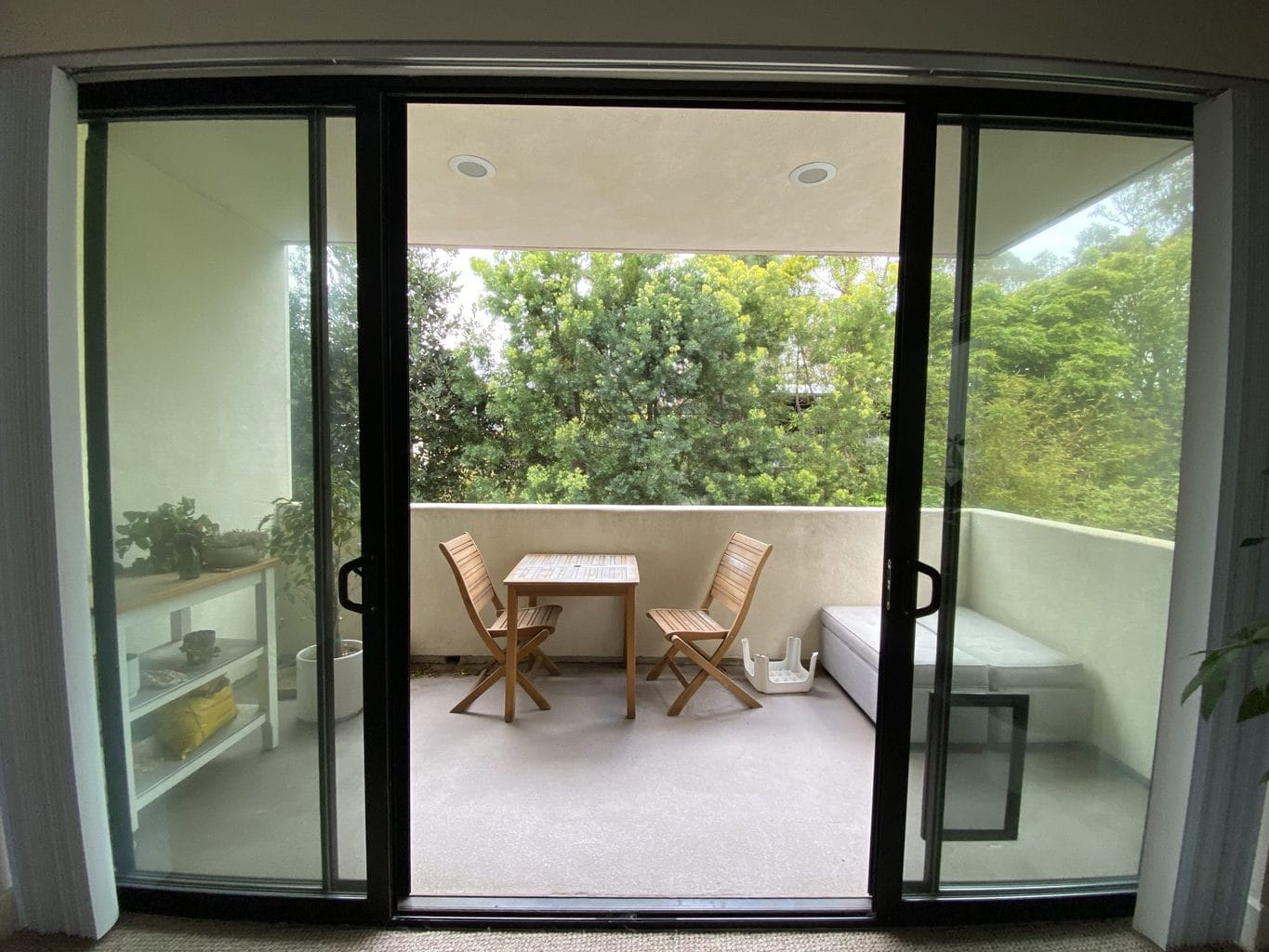 The before image of the patio makeover with minimal furniture and decor. 