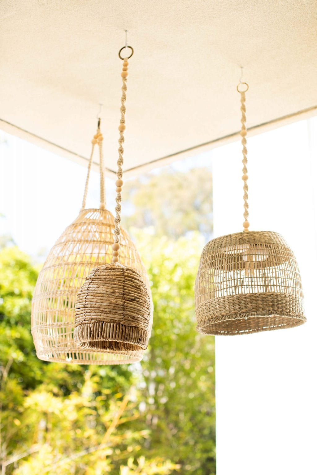 DIY Wireless Basket Lanterns hanging from an eye hook in the ceiling. 