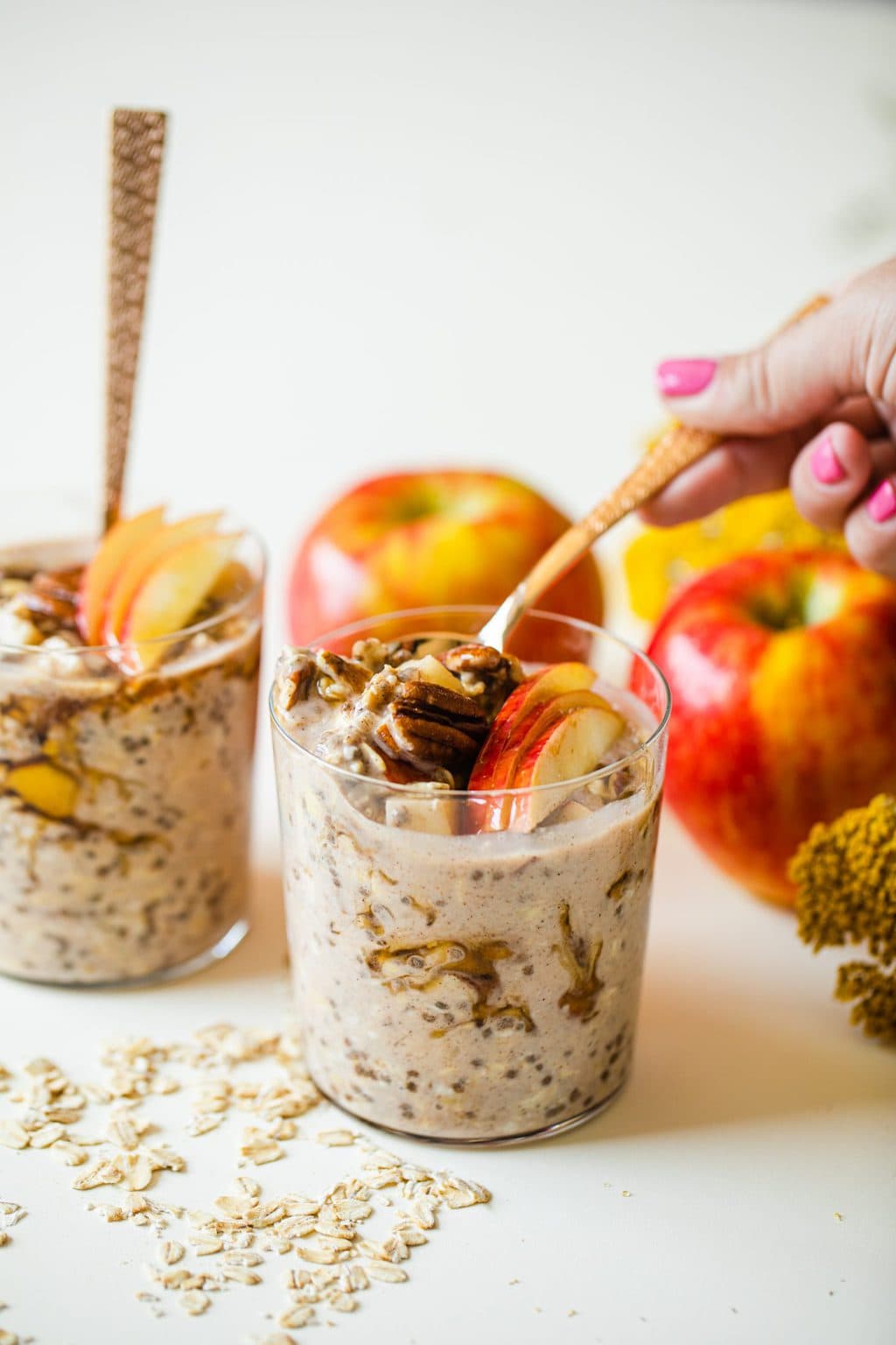 gold spoon in overnight oats with apple