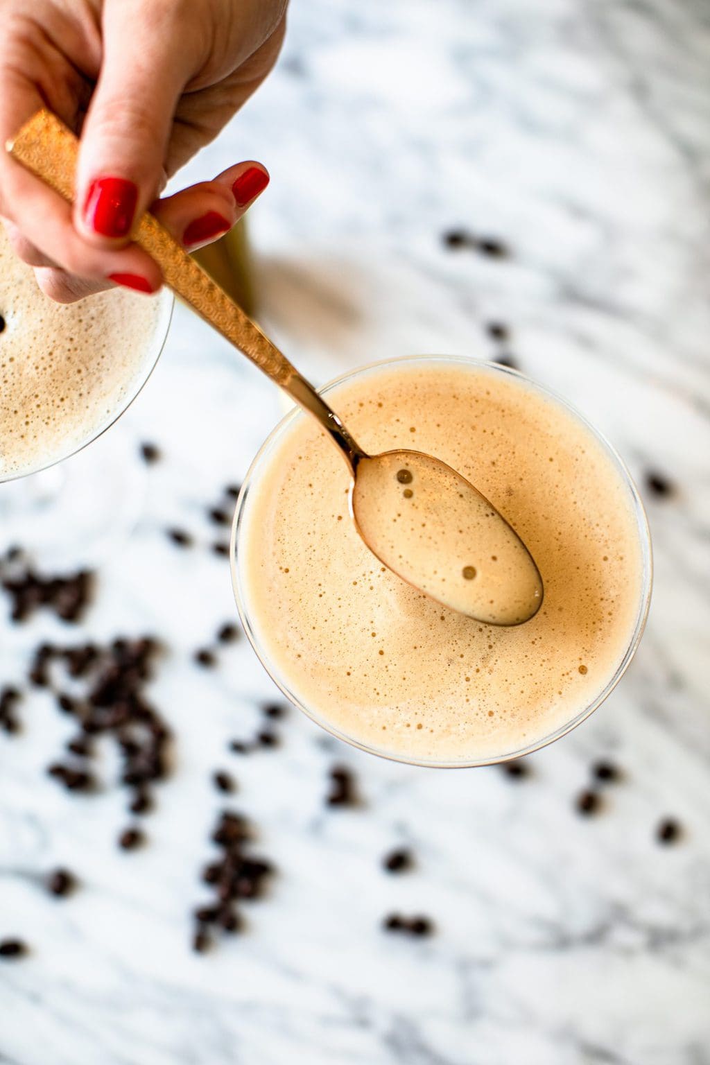 spooning foam into espresso martini