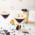 two espresso martinis garnished with three coffee beans each