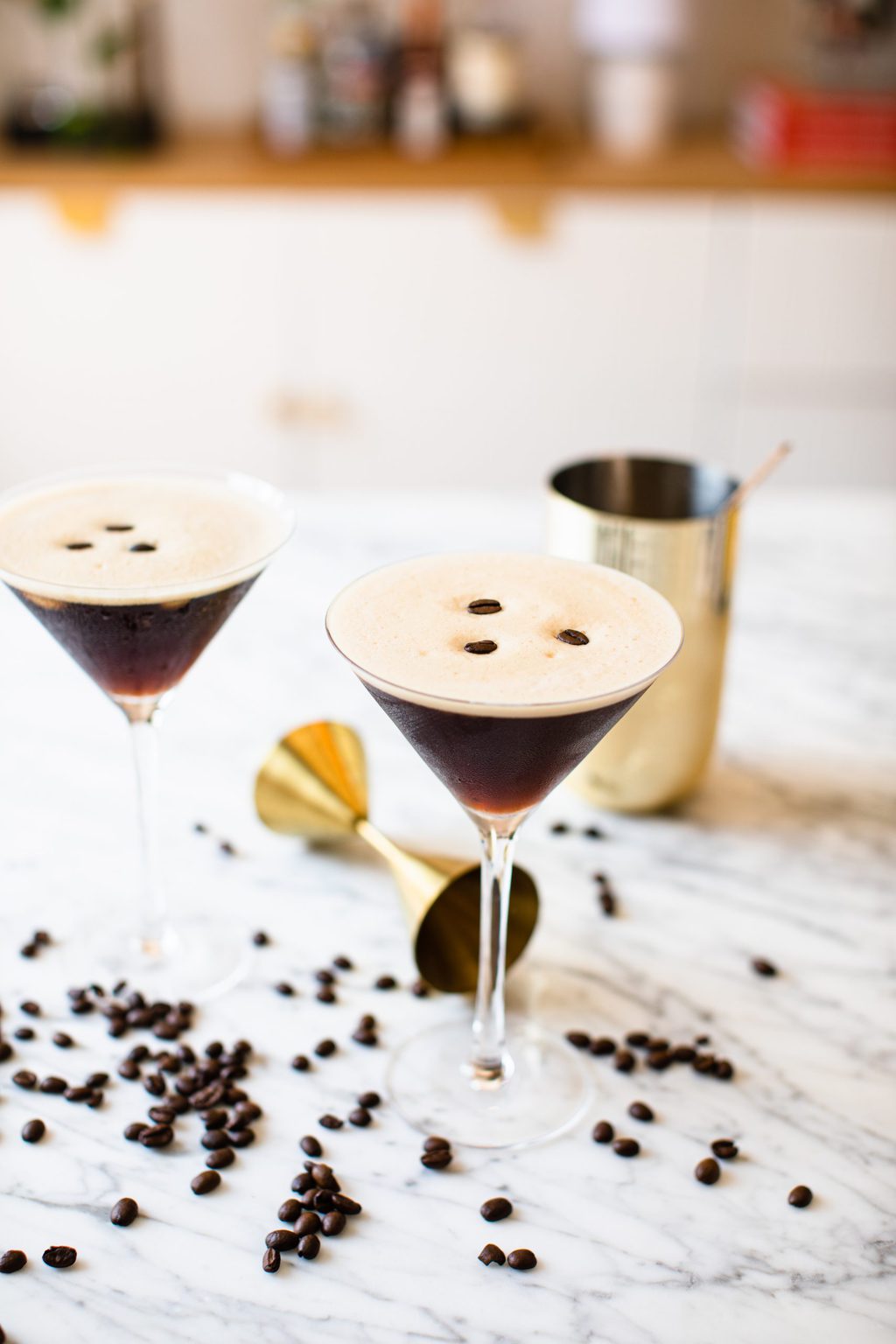 two espresso martinis garnished with three coffee beans each