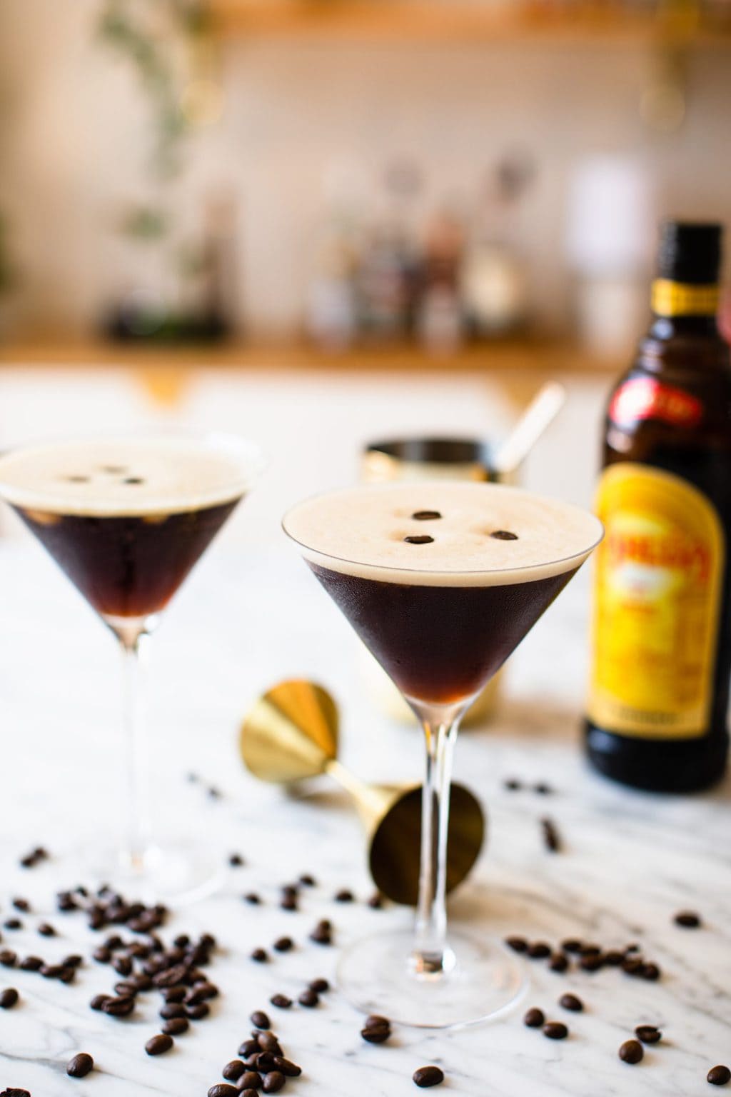 two espresso martinis garnished with three coffee beans each