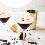 two espresso martinis garnished with three coffee beans each