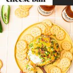 cheese ball on yellow platter with round crackers