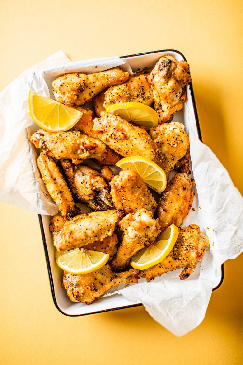 crispy baked chicken wings with lemon wedges