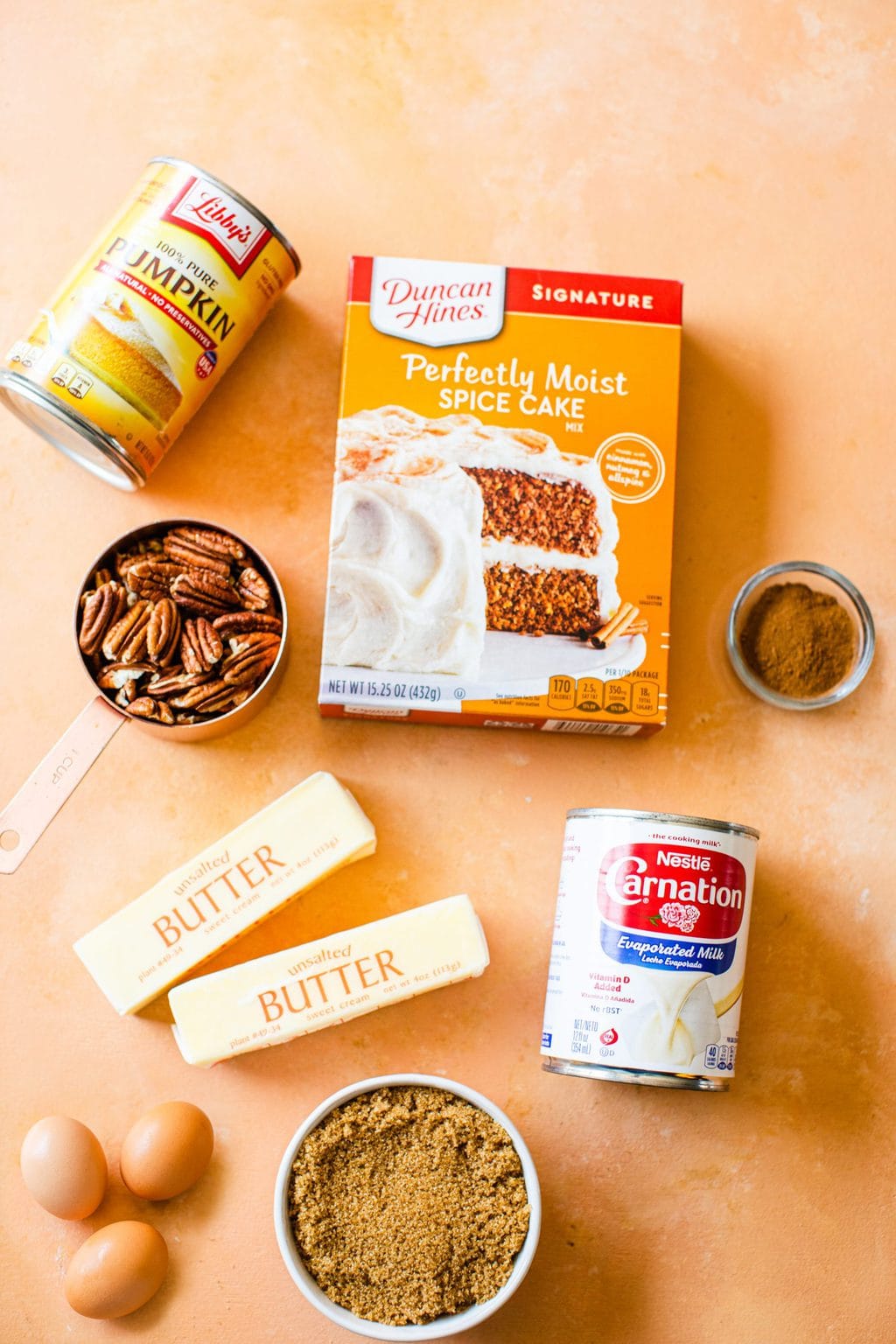 pumpkin puree, pecans, butter, eggs, brown sugar, spice cake mix, evaporated milk, pumpkin pie spice