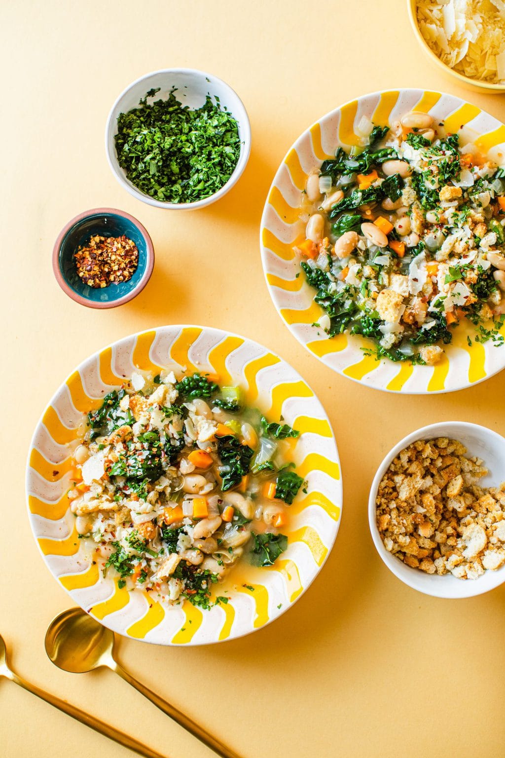 two bowls of white bean soup with toppings