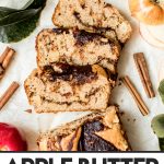 sliced apple loaf cake with cinnamon sticks and apples