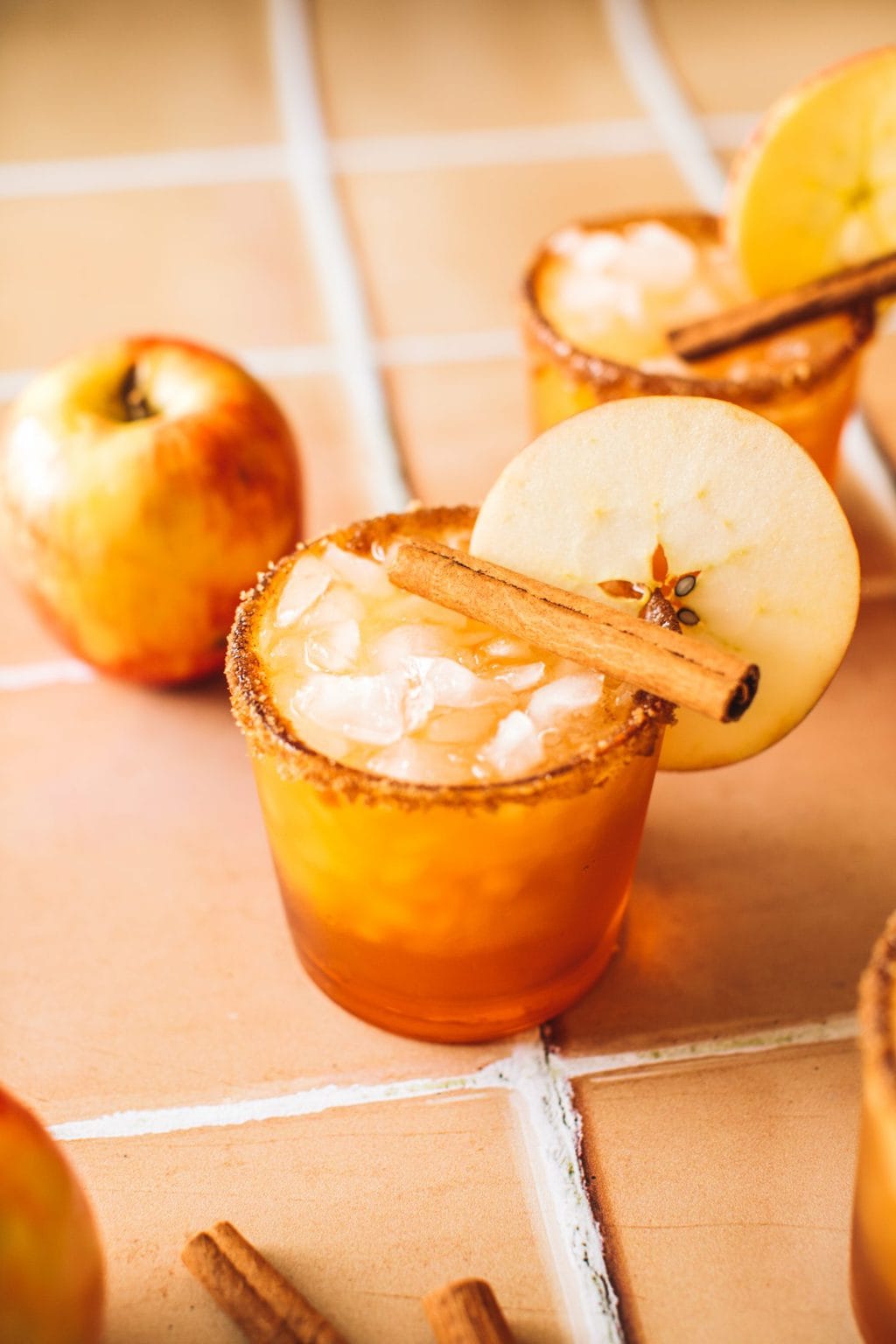 apple cider margarita in glass with apple slice garnish