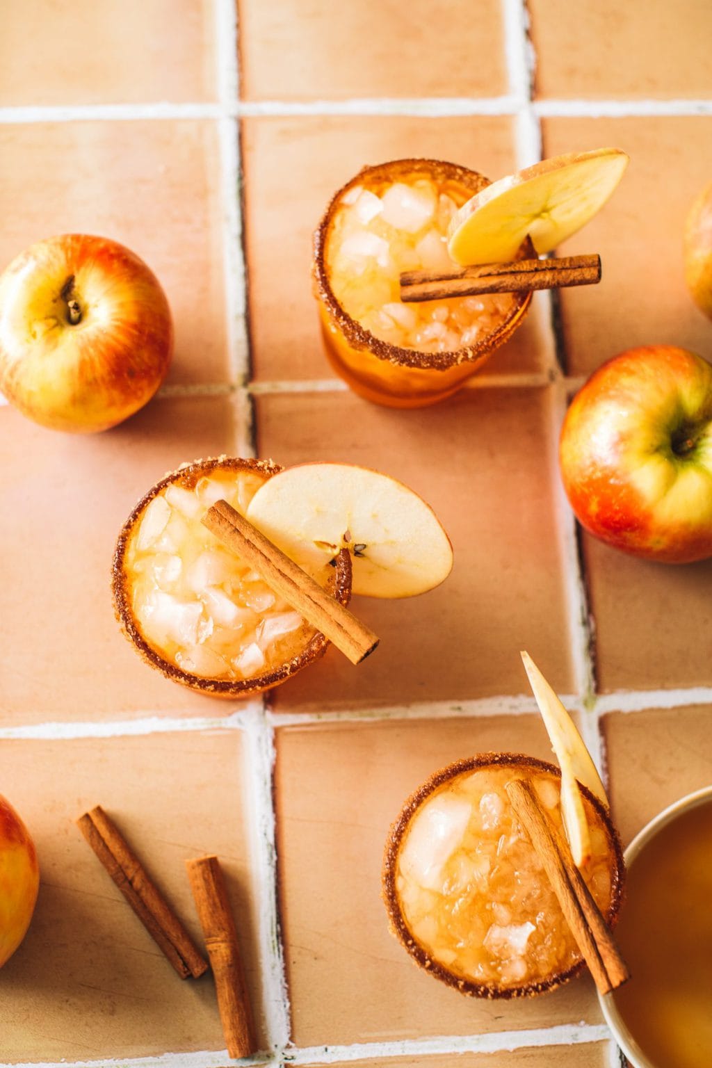 apple cider margaritas in glasses with apple slice garnish